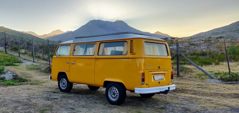 yellow van on gray sand under white sky during daytime