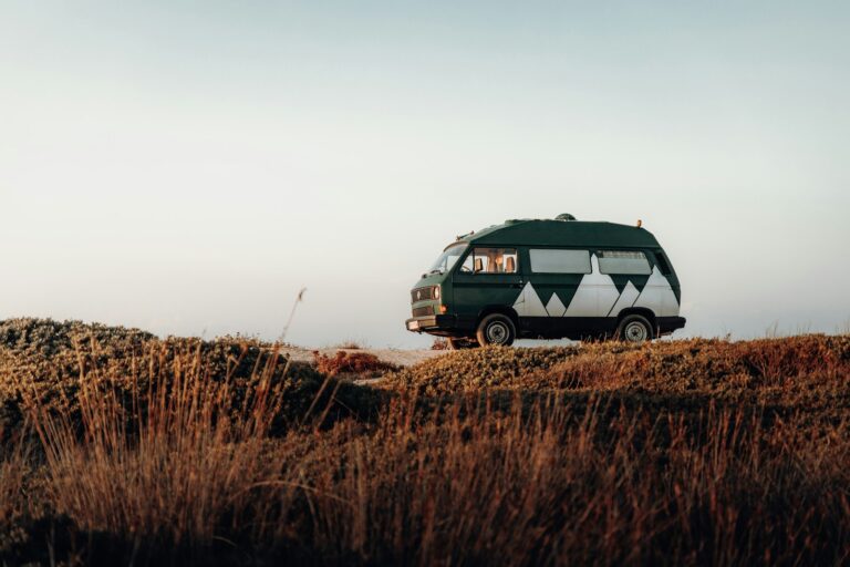 a van is parked on a grassy hill