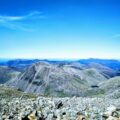 a view of a mountain range from the top of a hill