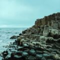 a large body of water next to a rocky shore