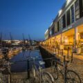 three commuter bikes parked beside harbor