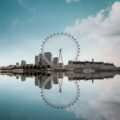 ferris wheel beside body of water under blue sky during daytime