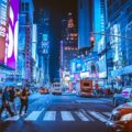 people walking on pedestrian lane during night time