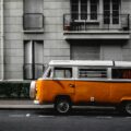 white and orange Volkswagen Kombi on road