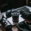 black and silver dslr camera lens on brown wooden table