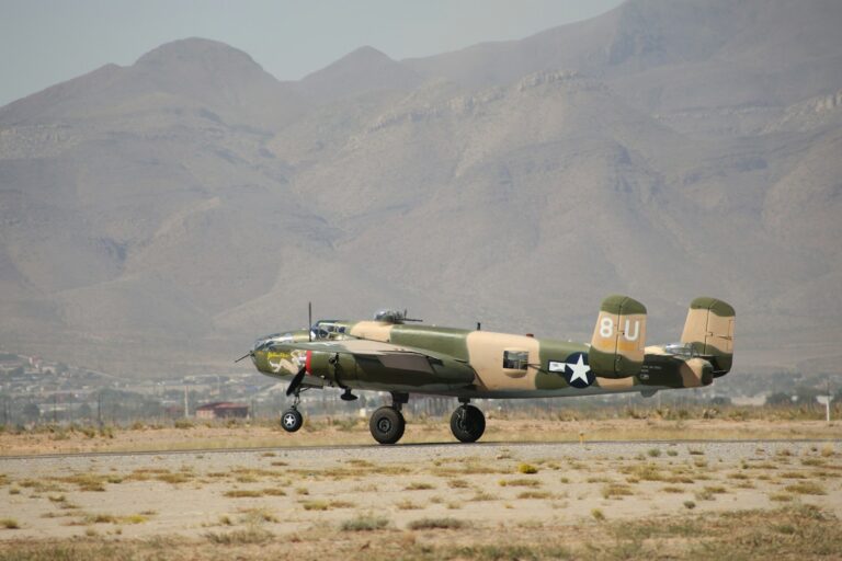 A military plane sitting on top of an airport runway