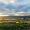 a view of the countryside from the top of a hill